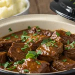Tender and juicy Crockpot steak bites slow-cooked to perfection, served with fresh parsley garnish.
